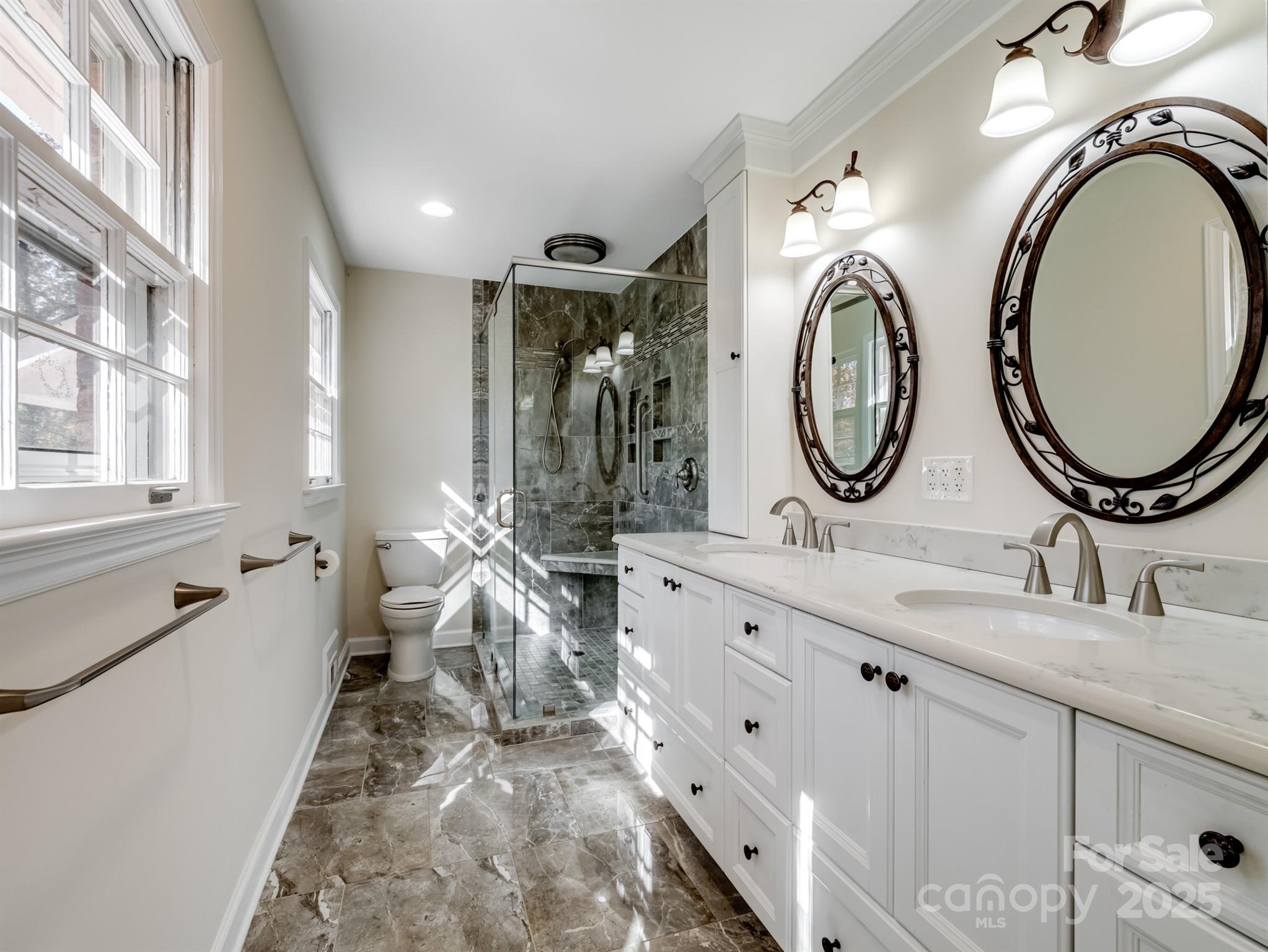 2111 Sagamore Road Charlotte, NC 28209 - Photo 23 of 48 a bathroom with double vanity and a mirror