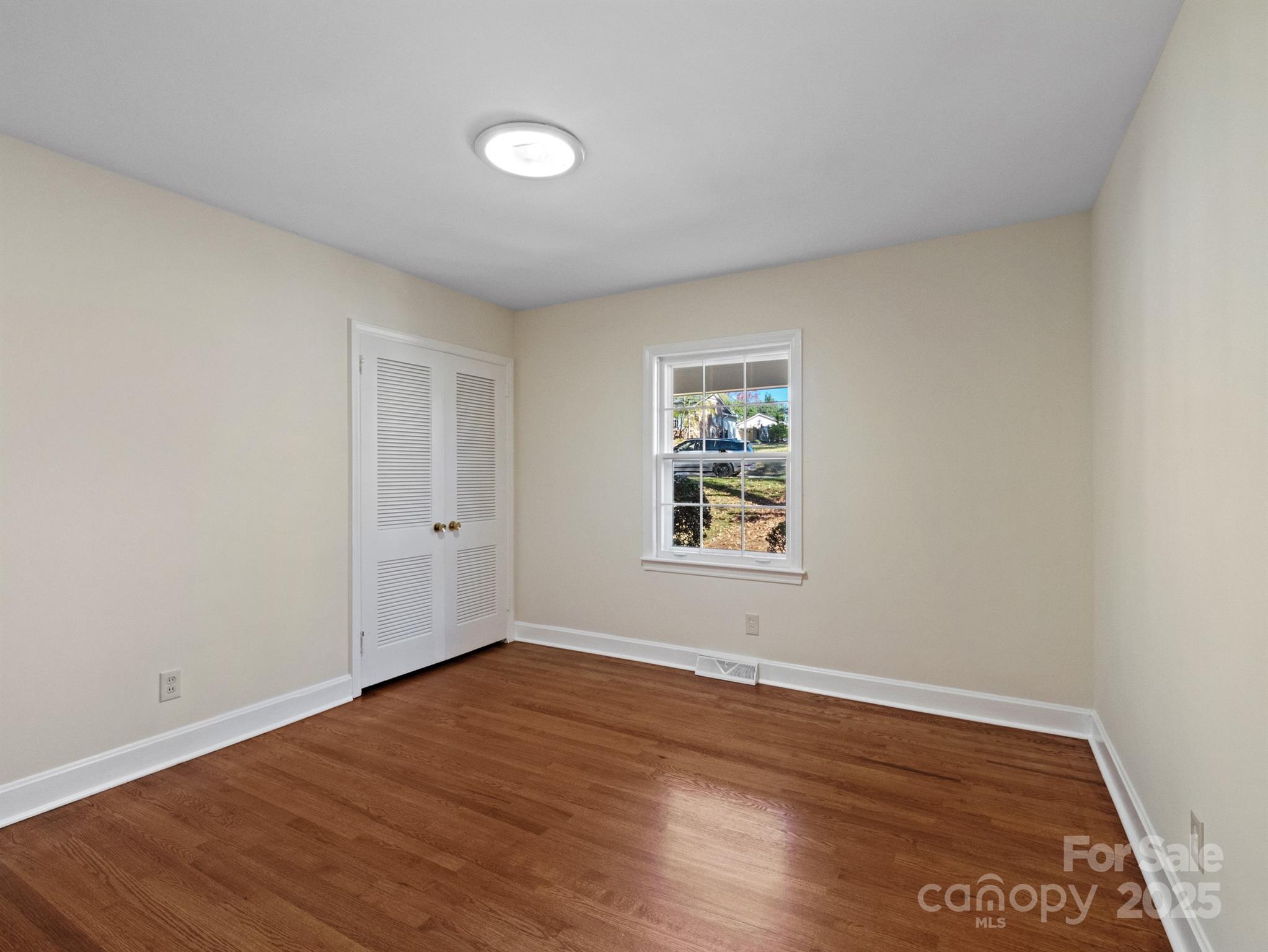 2111 Sagamore Road Charlotte, NC 28209 - Photo 25 of 48 an empty room with wooden floor and windows