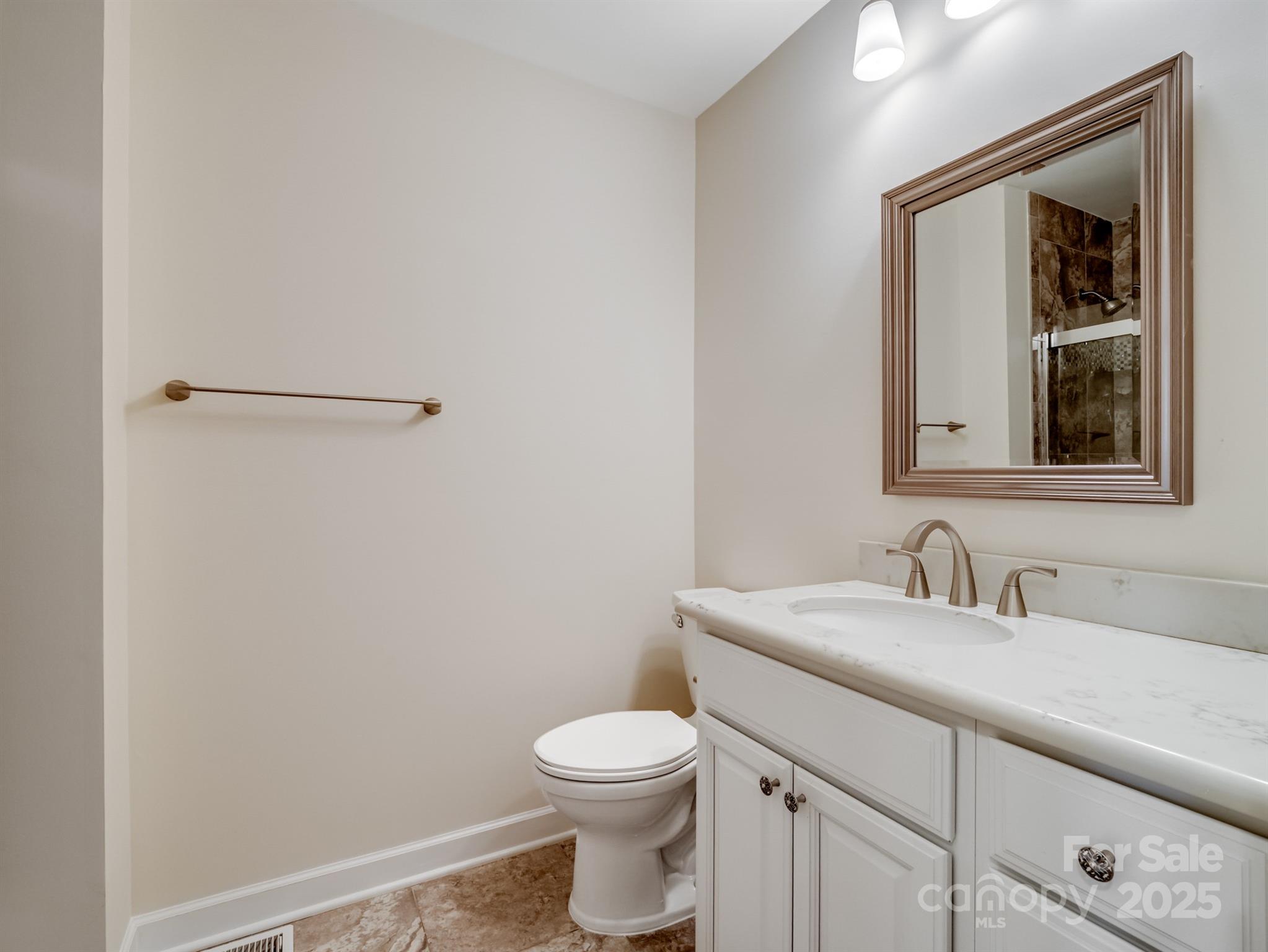 2111 Sagamore Road Charlotte, NC 28209 - Photo 27 of 48 a bathroom with a toilet sink and mirror