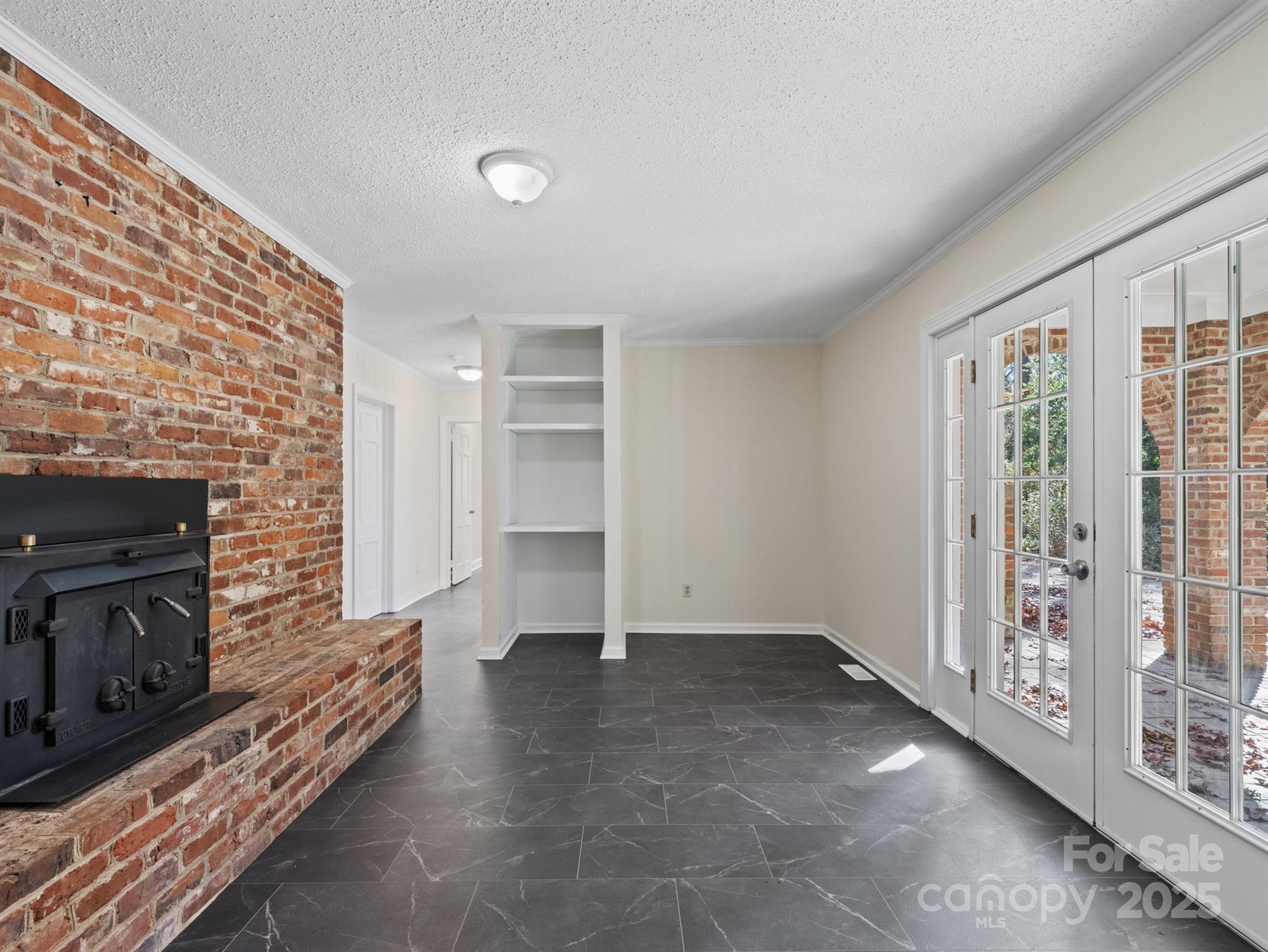 2111 Sagamore Road Charlotte, NC 28209 - Photo 33 of 48 a view of an empty room with fireplace and a window
