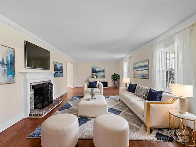 a living room with furniture a fireplace and a flat screen tv