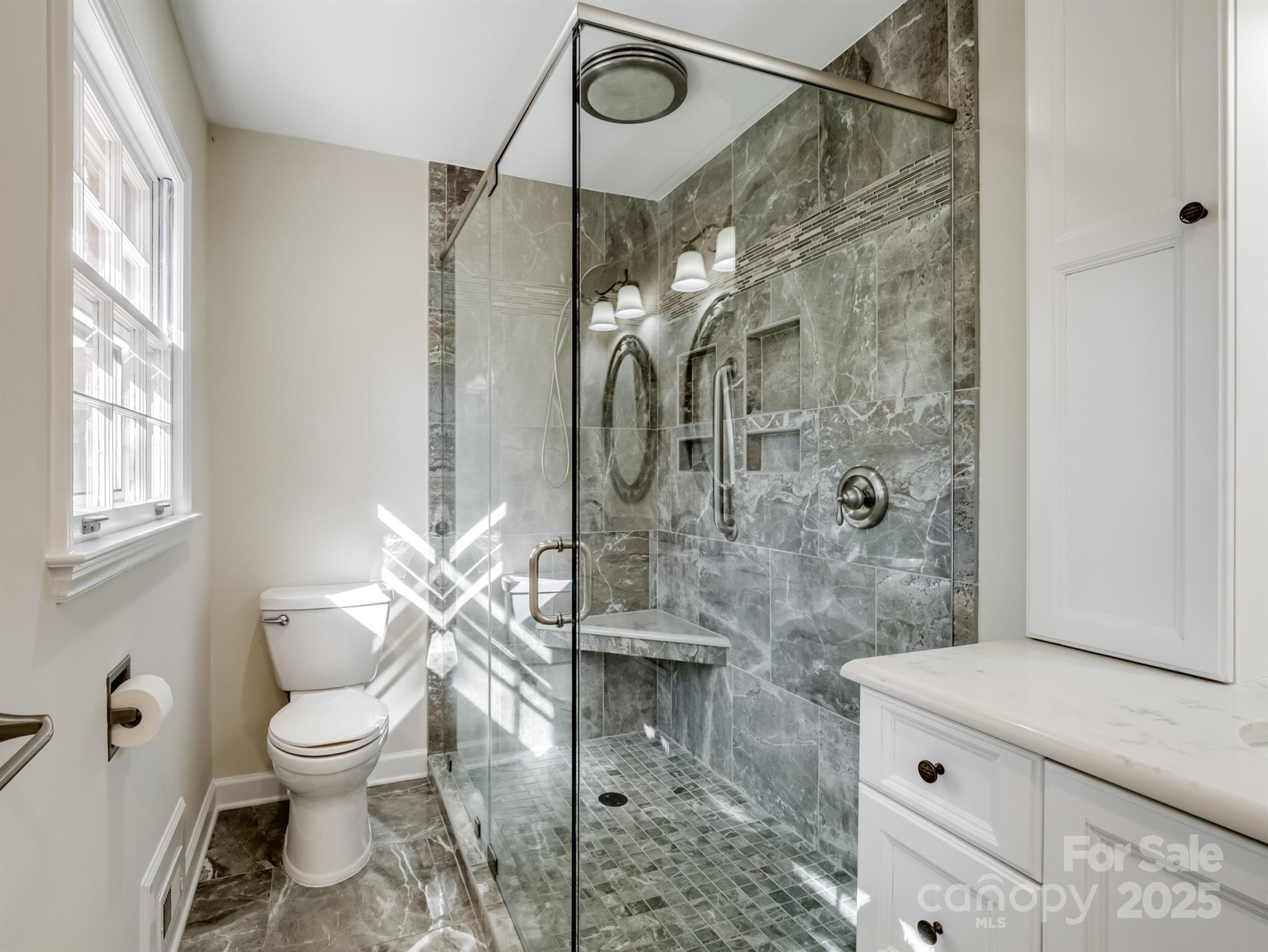 2111 Sagamore Road Charlotte, NC 28209 - Photo 5 of 48 a bathroom with a granite countertop shower a toilet and a sink