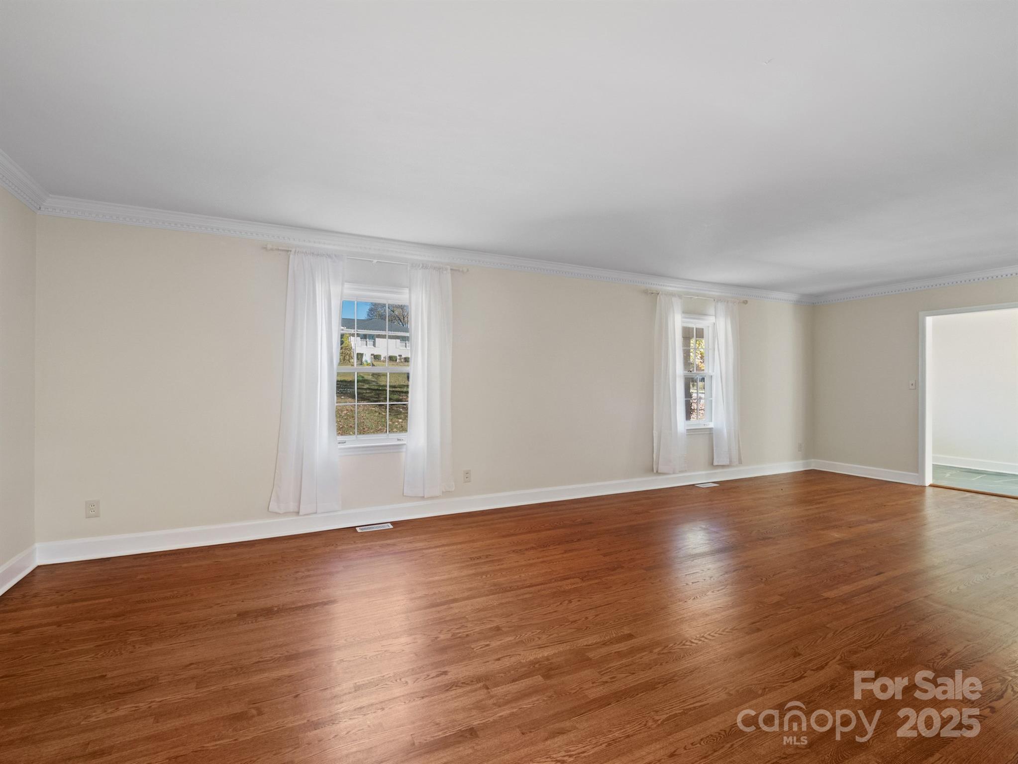 2111 Sagamore Road Charlotte, NC 28209 - Photo 10 of 48 a view of an empty room with wooden floor and a window