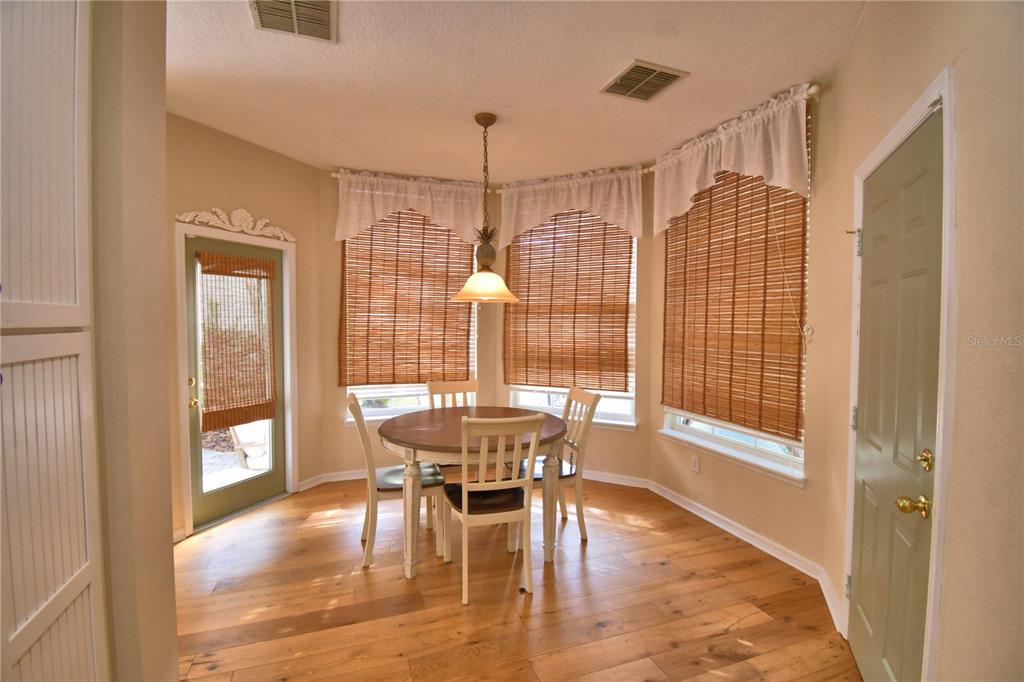908 Yew Court Celebration, FL 34747 - Photo 30 of 78 a view of a dining room with furniture window and wooden floor