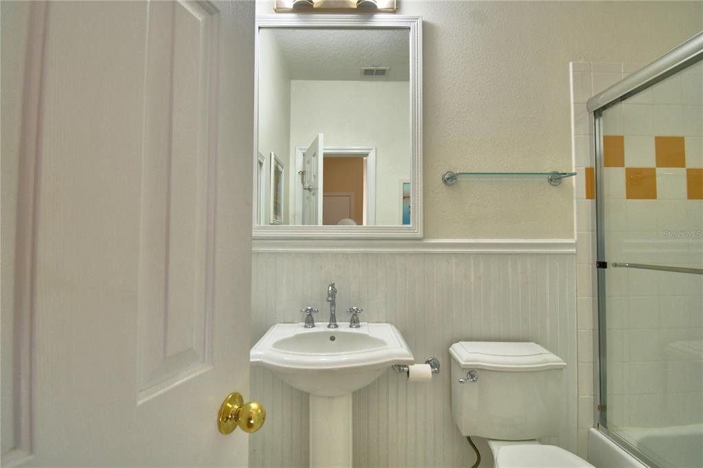 908 Yew Court Celebration, FL 34747 - Photo 47 of 78 a bathroom with a toilet a sink and mirror