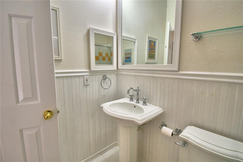 908 Yew Court Celebration, FL 34747 - Photo 48 of 78 a bathroom with a sink a toilet and mirror