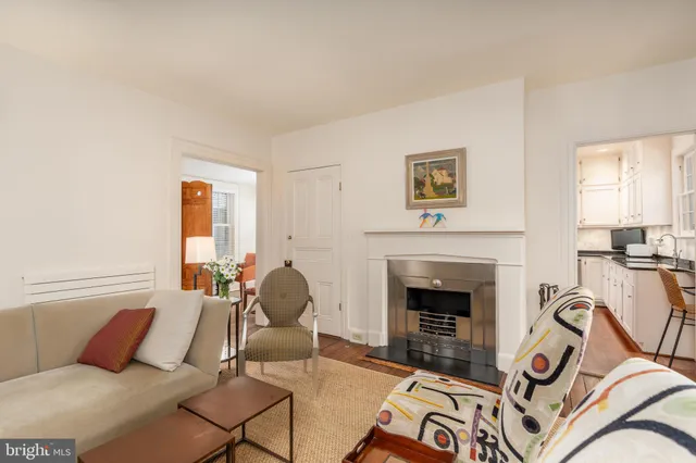 a living room with furniture a fireplace and a window