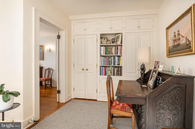 a view of a workspace with furniture and closet