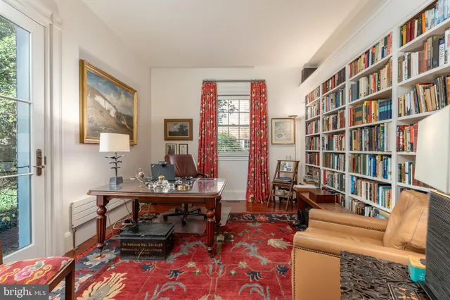 a reading room with furniture and a book shelf