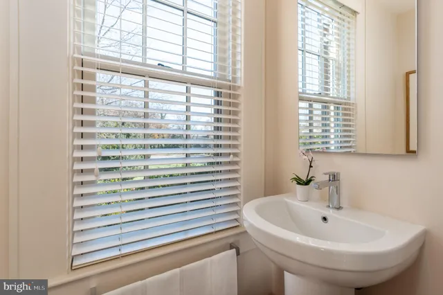 a bathroom with a sink and a window