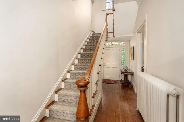 a view of entryway and hall with wooden floor