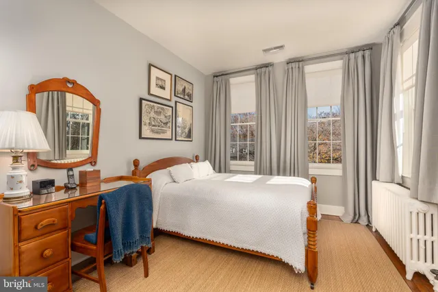 a bedroom with a bed dresser and a window