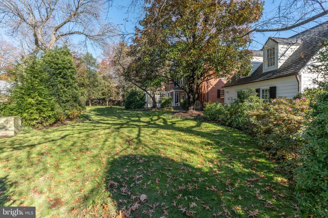a view of a house with a yard and potted plants
