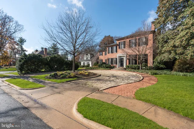 a view of a white house with a yard patio and a small yard