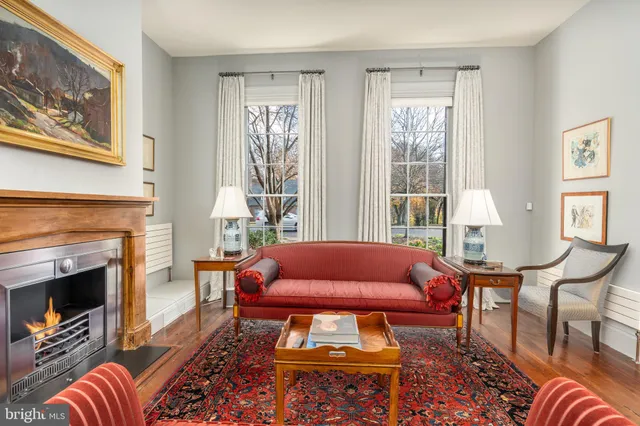 a living room with furniture a fireplace and next to a window