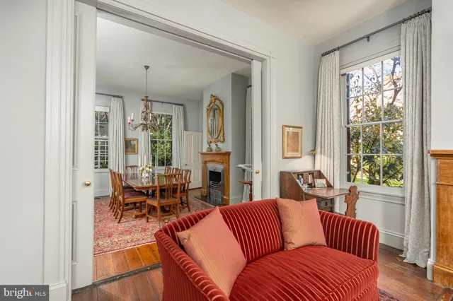 a living room with furniture wooden floor and a large window