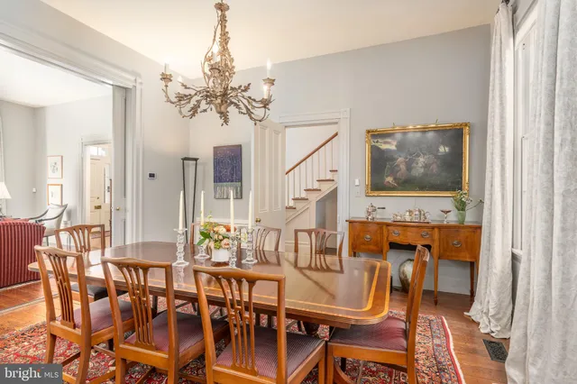 a view of a dining room with furniture and chandelier