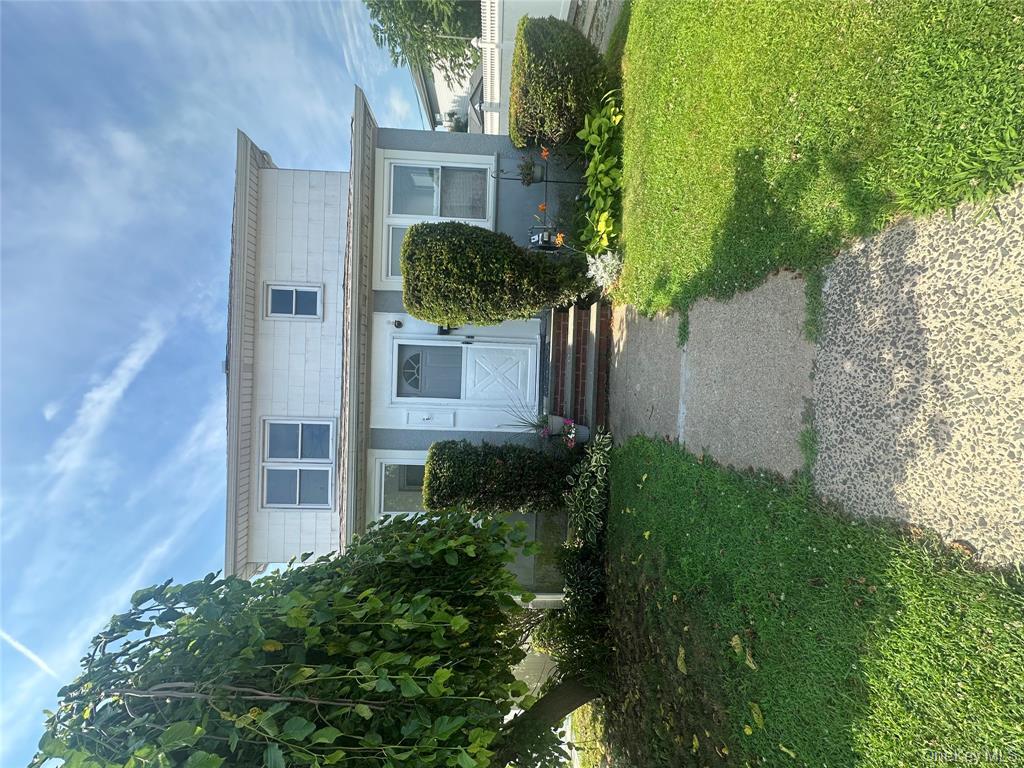 25 Concord Street Lynbrook, NY 11563 - Photo 1 of 11 a front view of house with yard and green space