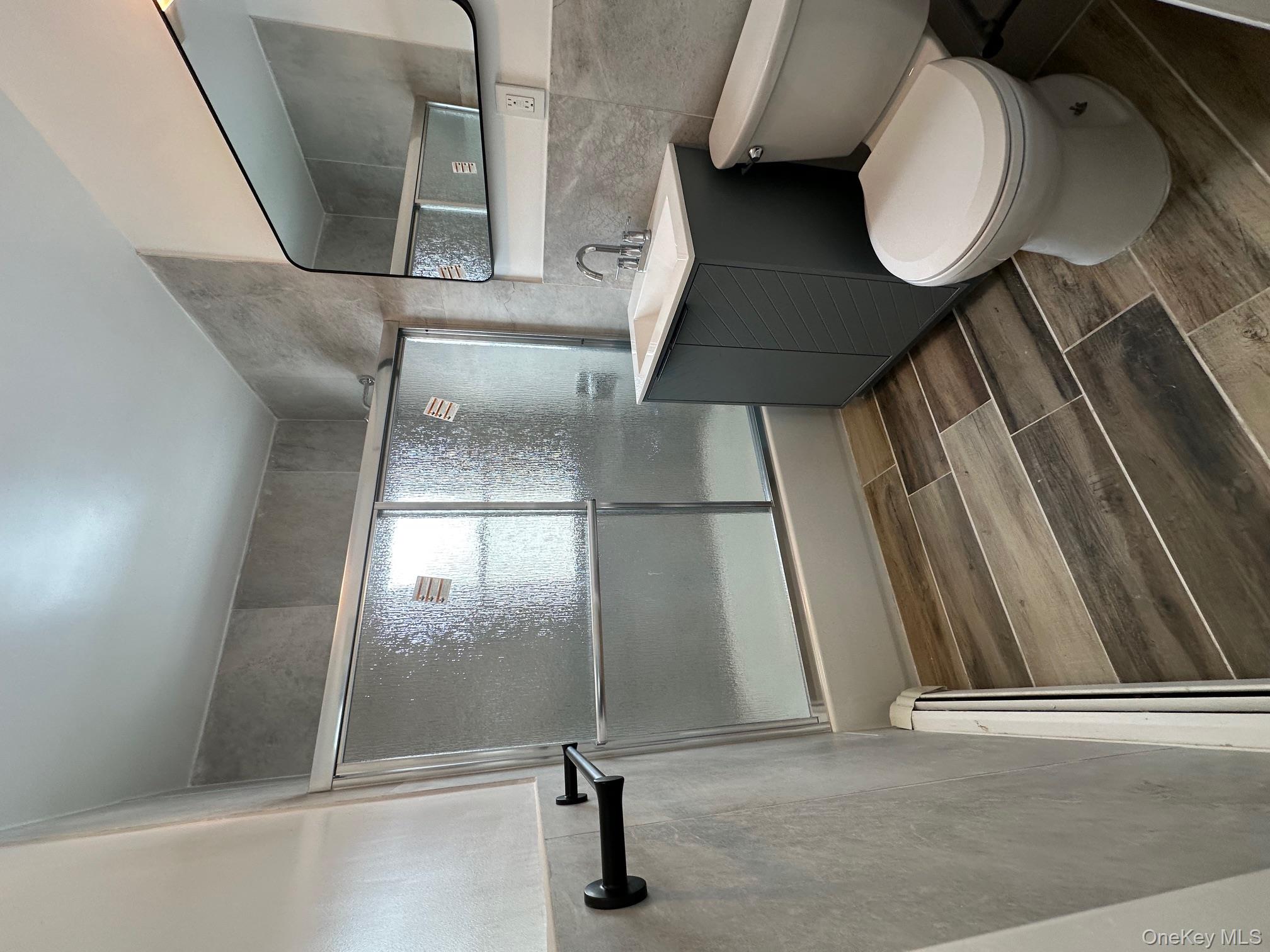 25 Concord Street Lynbrook, NY 11563 - Photo 3 of 11 a bathroom with a toilet sink and shower