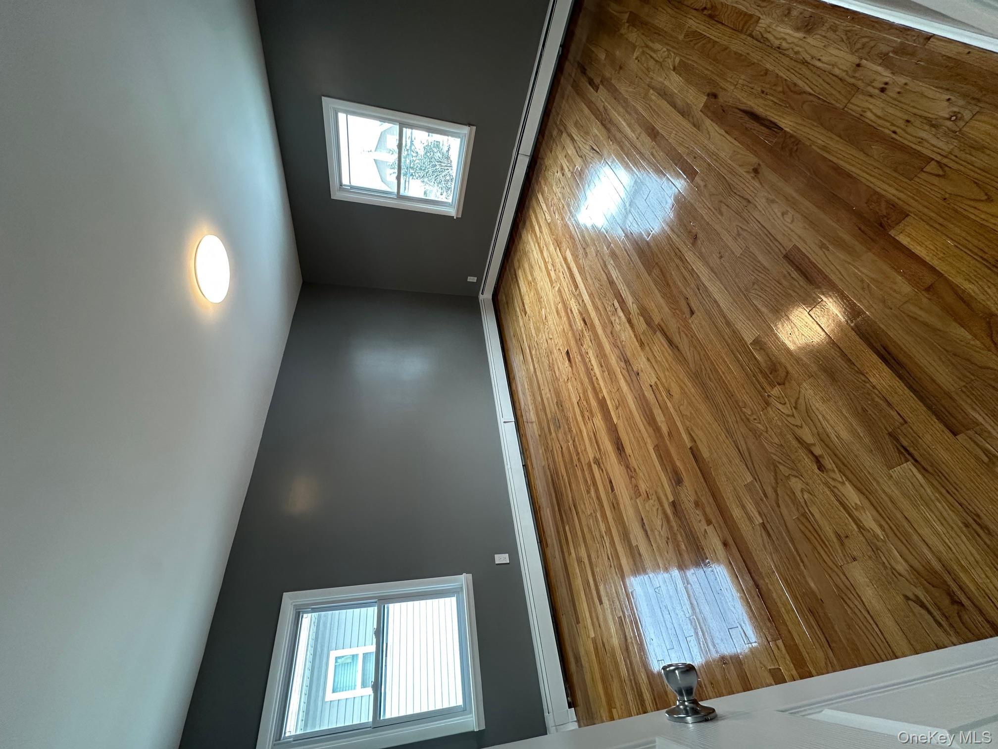 25 Concord Street Lynbrook, NY 11563 - Photo 6 of 11 a view of empty room with window and wooden floor
