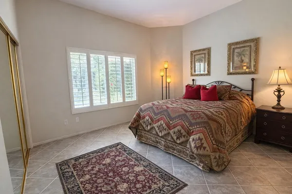a bedroom with a bed and glass window