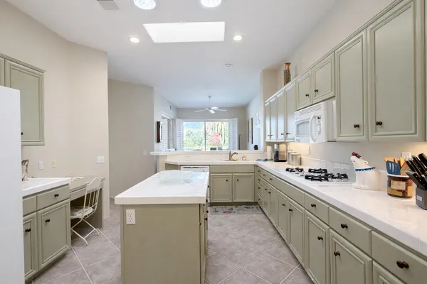 a kitchen that has a sink and a stove in it