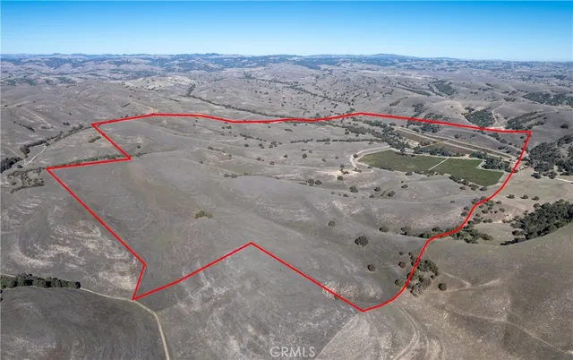 a view of a house next to a lake with a nearby beach