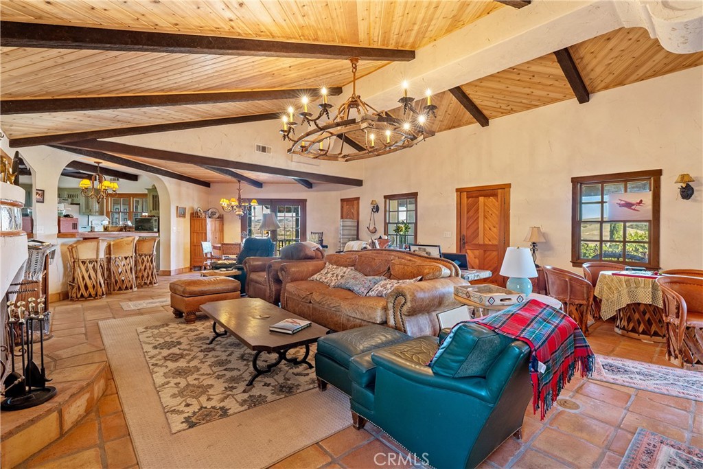 77620 Lowes Canyon Road San Miguel, CA 93451 - Photo 39 of 66 a living room with lots of furniture and a chandelier