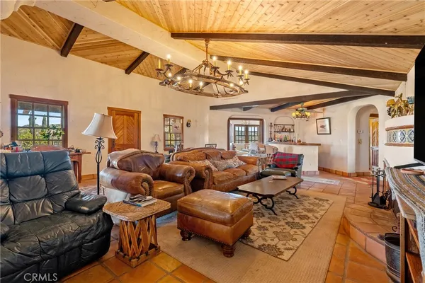 a living room with furniture a window and a chandelier