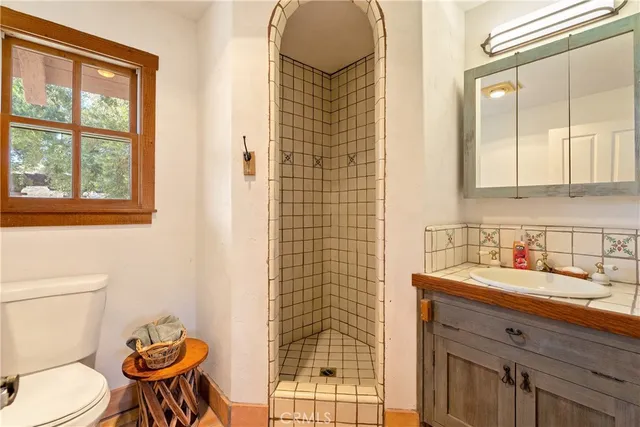 a spacious bathroom with a double vanity sink a mirror and a shower