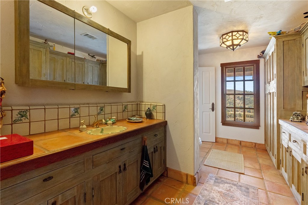77620 Lowes Canyon Road San Miguel, CA 93451 - Photo 50 of 66 a bathroom with a sink a vanity and a mirror