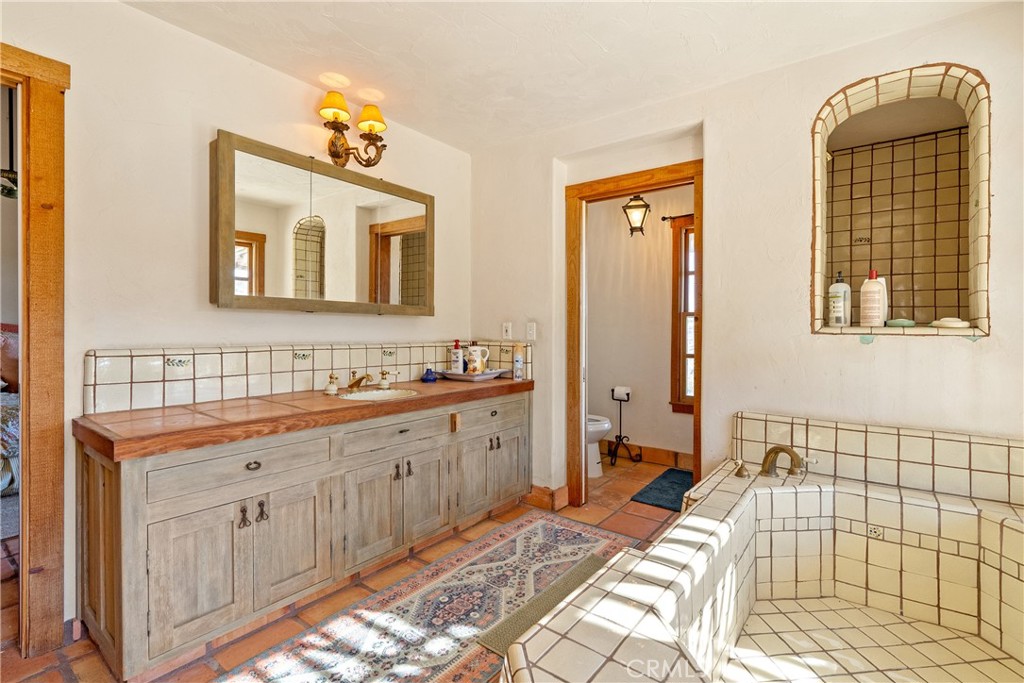 77620 Lowes Canyon Road San Miguel, CA 93451 - Photo 52 of 56 a spacious bathroom with a double vanity sink a mirror and a shower