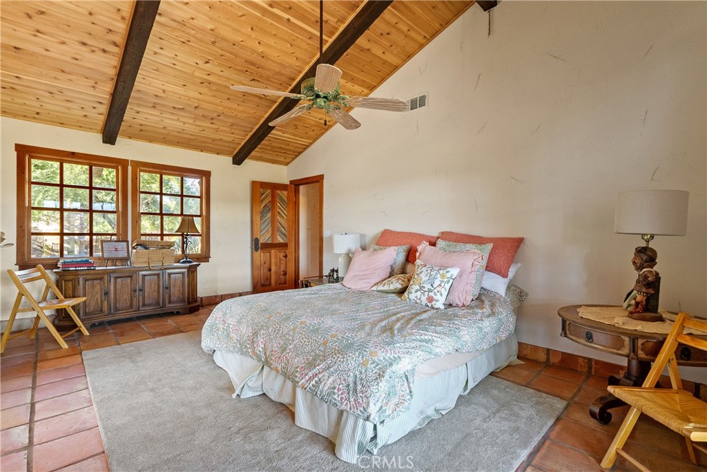 77620 Lowes Canyon Road San Miguel, CA 93451 - Photo 54 of 66 a bedroom with a bed next to a window with chair and table
