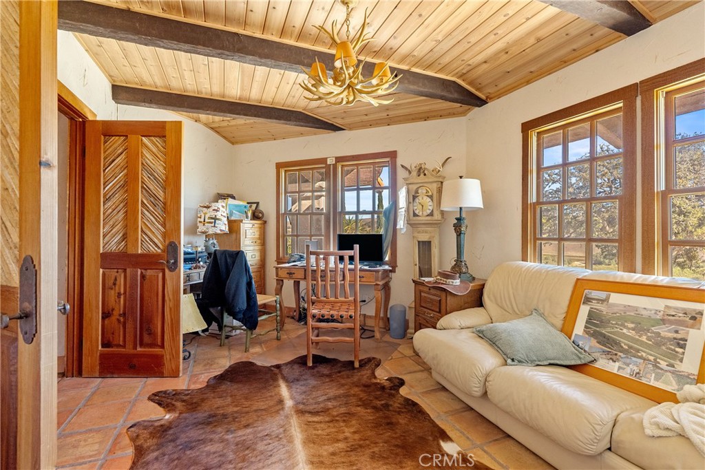 77620 Lowes Canyon Road San Miguel, CA 93451 - Photo 54 of 56 a living room with furniture a window and a chandelier