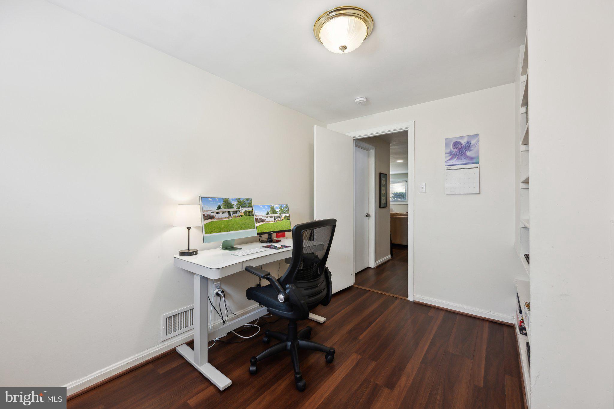 10108 Kinross Avenue Silver Spring, MD 20901 - Photo 13 of 22 a view of a workspace with furniture and wooden floor