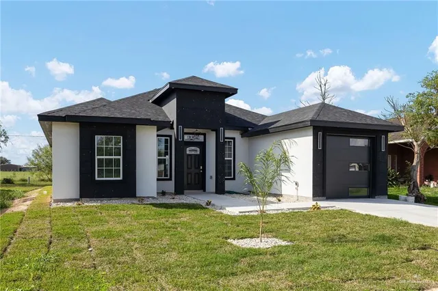 a view of a house with a yard and porch