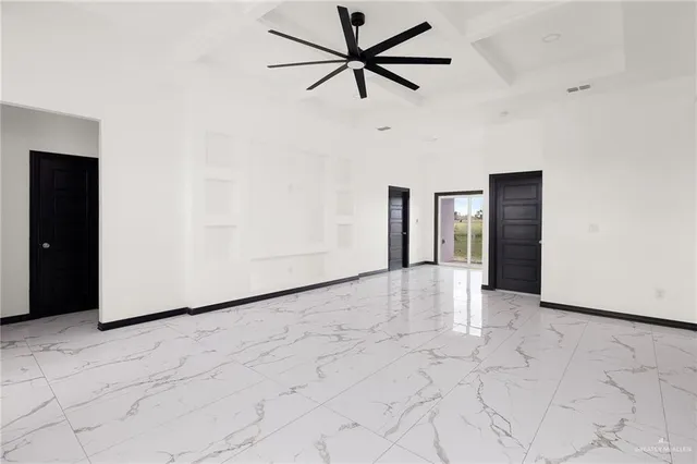a view of a livingroom with a ceiling fan and window