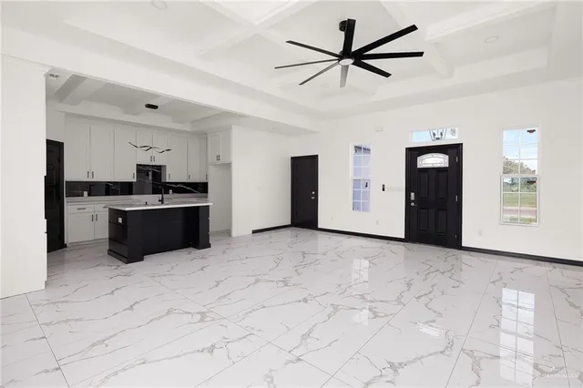 a view of a kitchen with a sink and a refrigerator