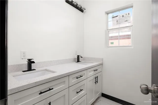 a bathroom with a granite countertop sink