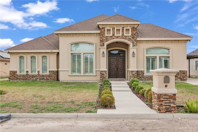 a front view of a house with garden