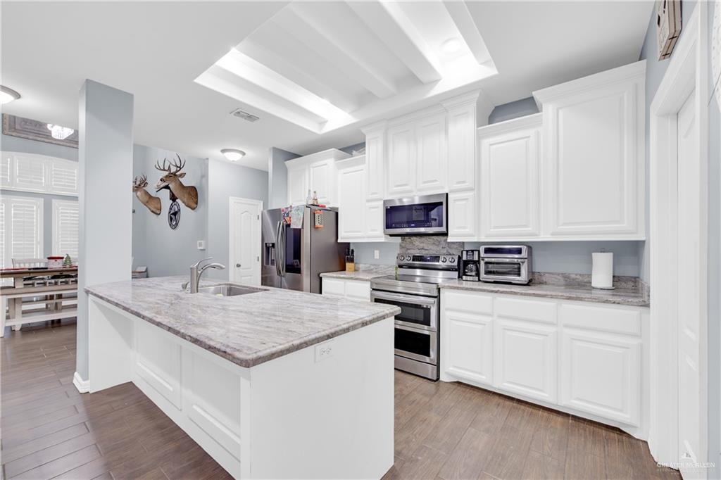 107 Nazareth Street Rio Grande City, TX 78582 - Photo 12 of 26 a kitchen with stainless steel appliances white cabinets and sink