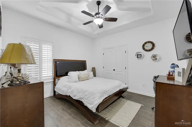 a bedroom with a bed and a ceiling fan