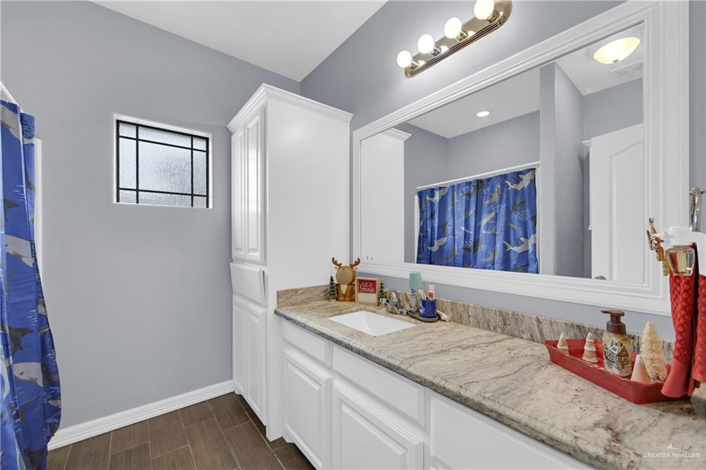 107 Nazareth Street Rio Grande City, TX 78582 - Photo 18 of 26 a bathroom with double vanity and a mirror