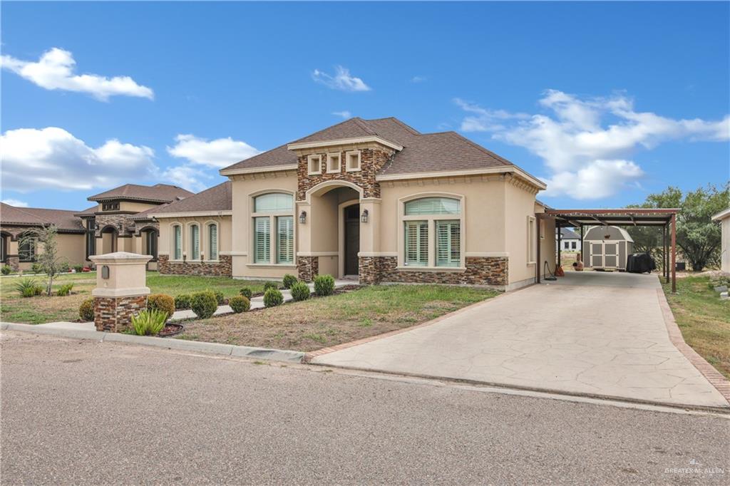 107 Nazareth Street Rio Grande City, TX 78582 - Photo 21 of 26 a front view of a house with a garden