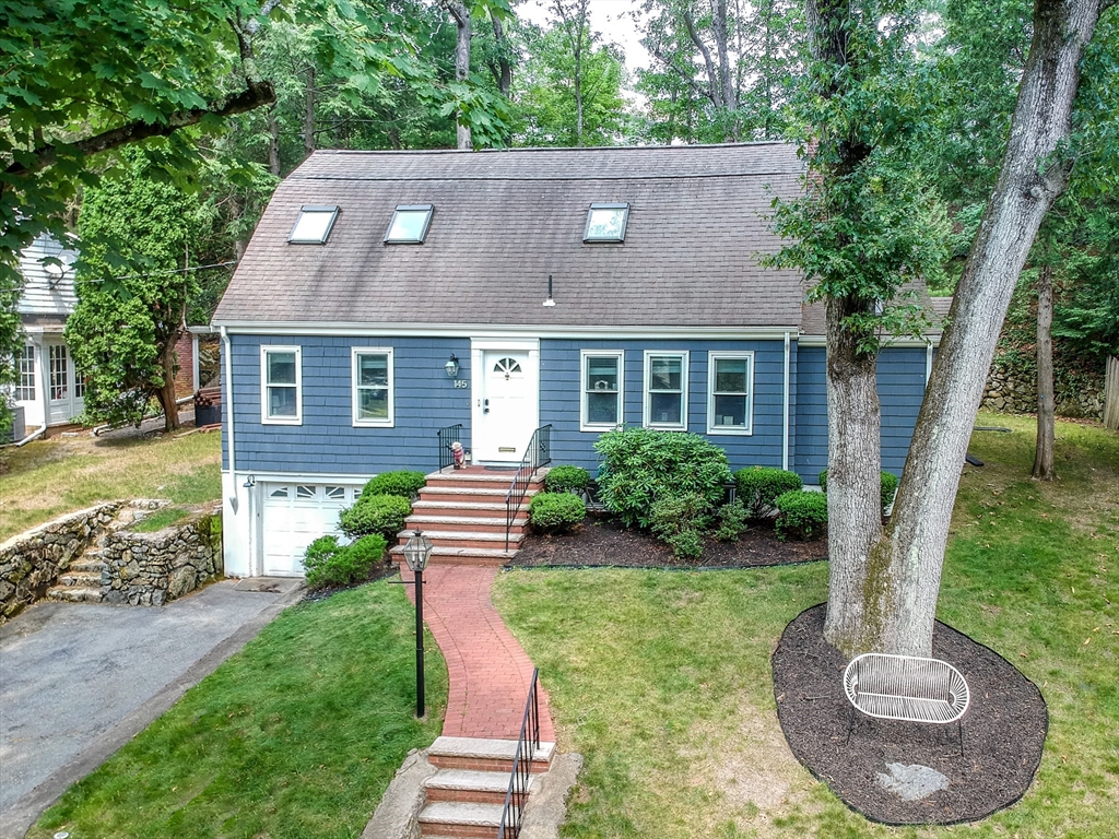 145 Pond Brook Road Newton, MA 02467 - Photo 1 of 39 a front view of a house with a yard