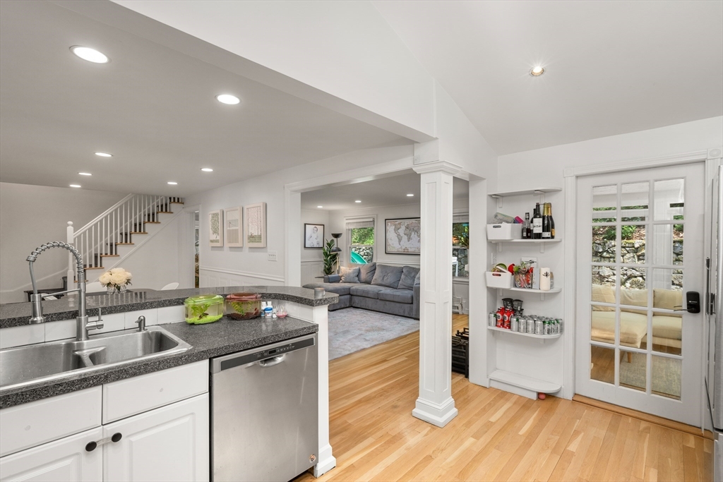 145 Pond Brook Road Newton, MA 02467 - Photo 11 of 39 a kitchen with stainless steel appliances granite countertop a sink and wooden cabinets