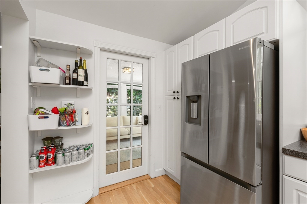 145 Pond Brook Road Newton, MA 02467 - Photo 12 of 39 a view of kitchen with refrigerator and wooden floor