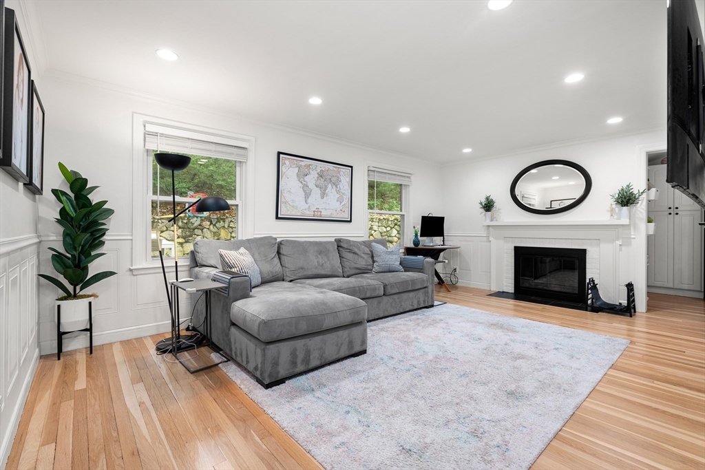 145 Pond Brook Road Newton, MA 02467 - Photo 15 of 39 a living room with furniture a fireplace and a flat screen tv