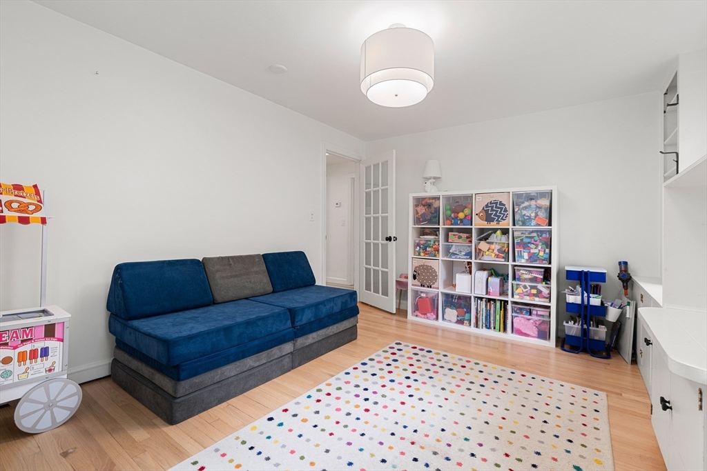 145 Pond Brook Road Newton, MA 02467 - Photo 21 of 39 a living room with a couch and a book shelf