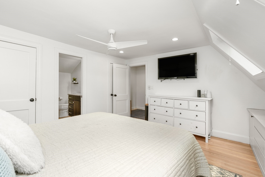 145 Pond Brook Road Newton, MA 02467 - Photo 23 of 39 a large bedroom with a bed and flat screen tv